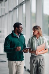 Business colleagues having a discussion while walking in a modern office