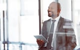 Shot of a businessman using a digital tablet at work